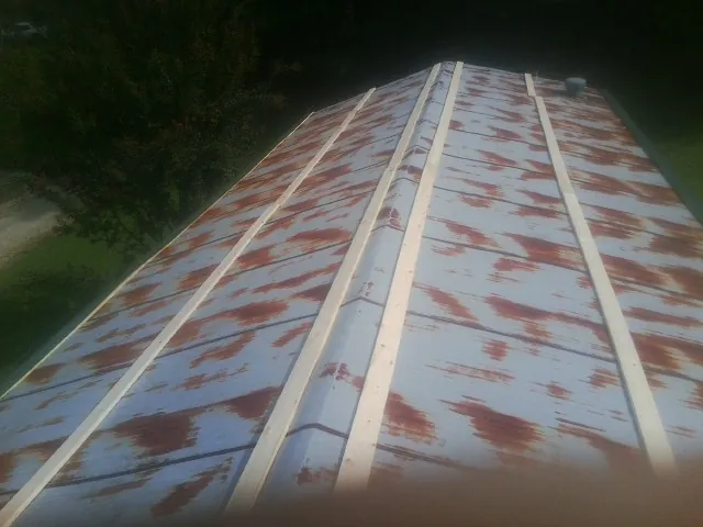 Rusted metal roof panels with new wood purlins before replacement — Storm Damage Roof Repair in Dunsmuir by Roofing Brothers