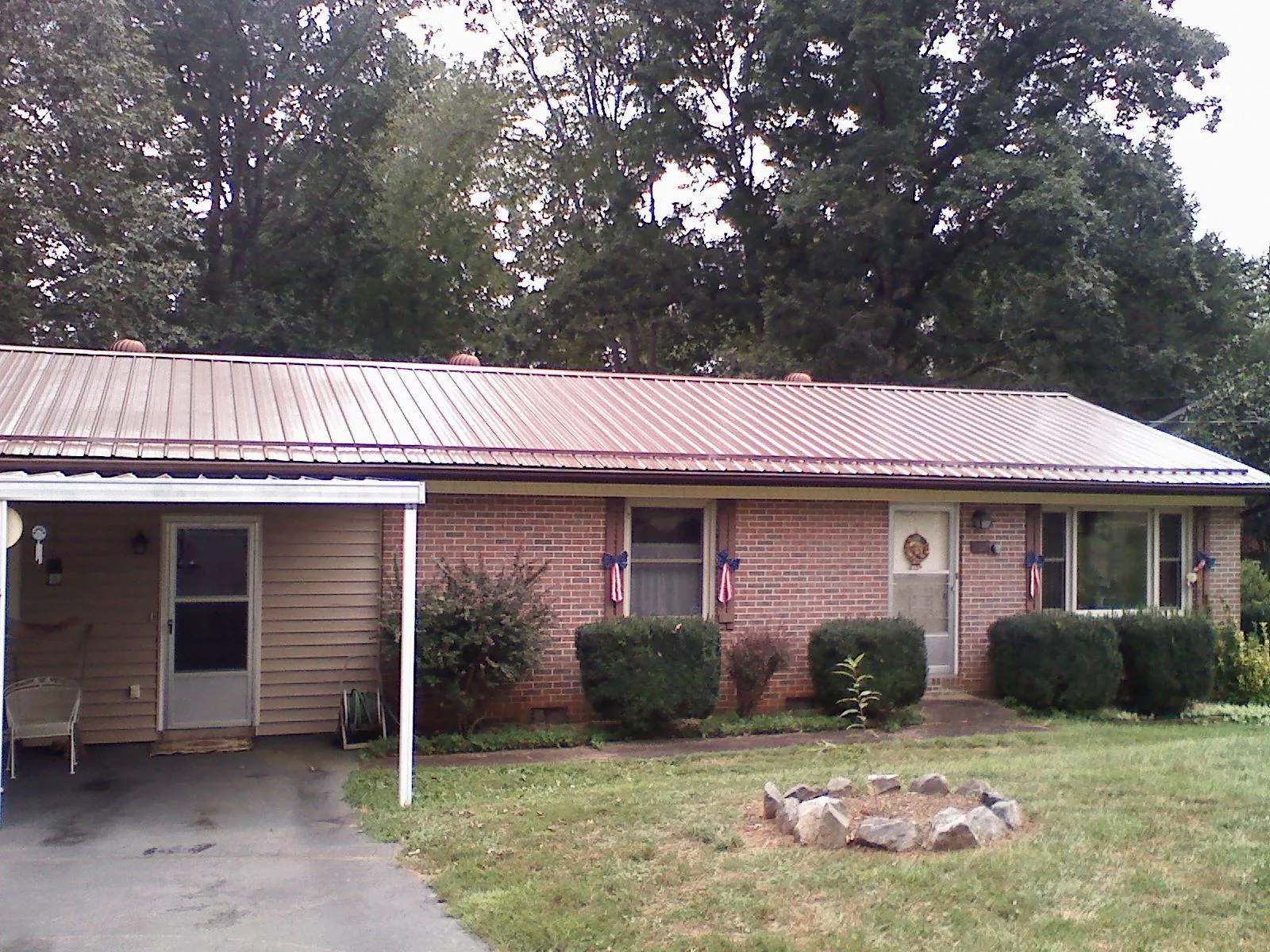 Bronze metal roof and carport on a brick ranch home — Roof Repair work by our crew in Dunsmuir